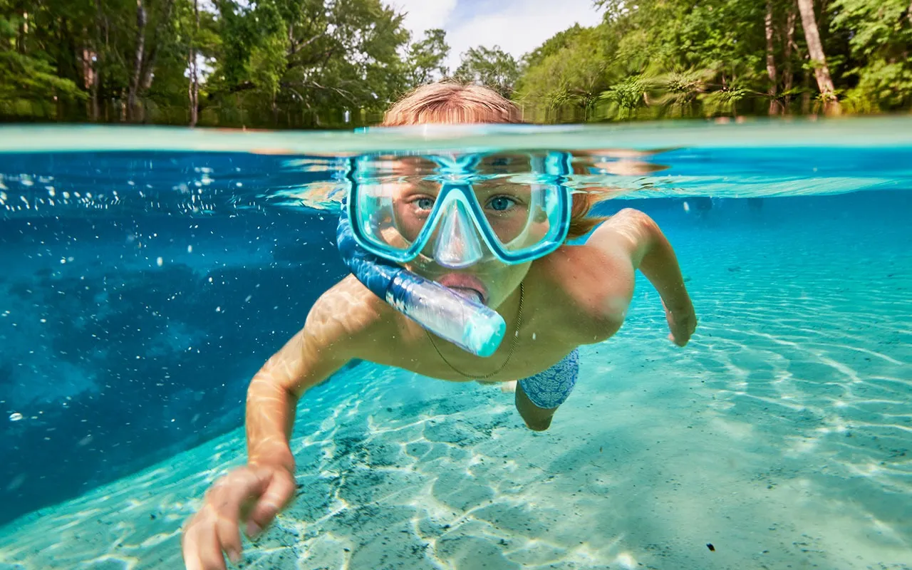 boy is swimming underwater