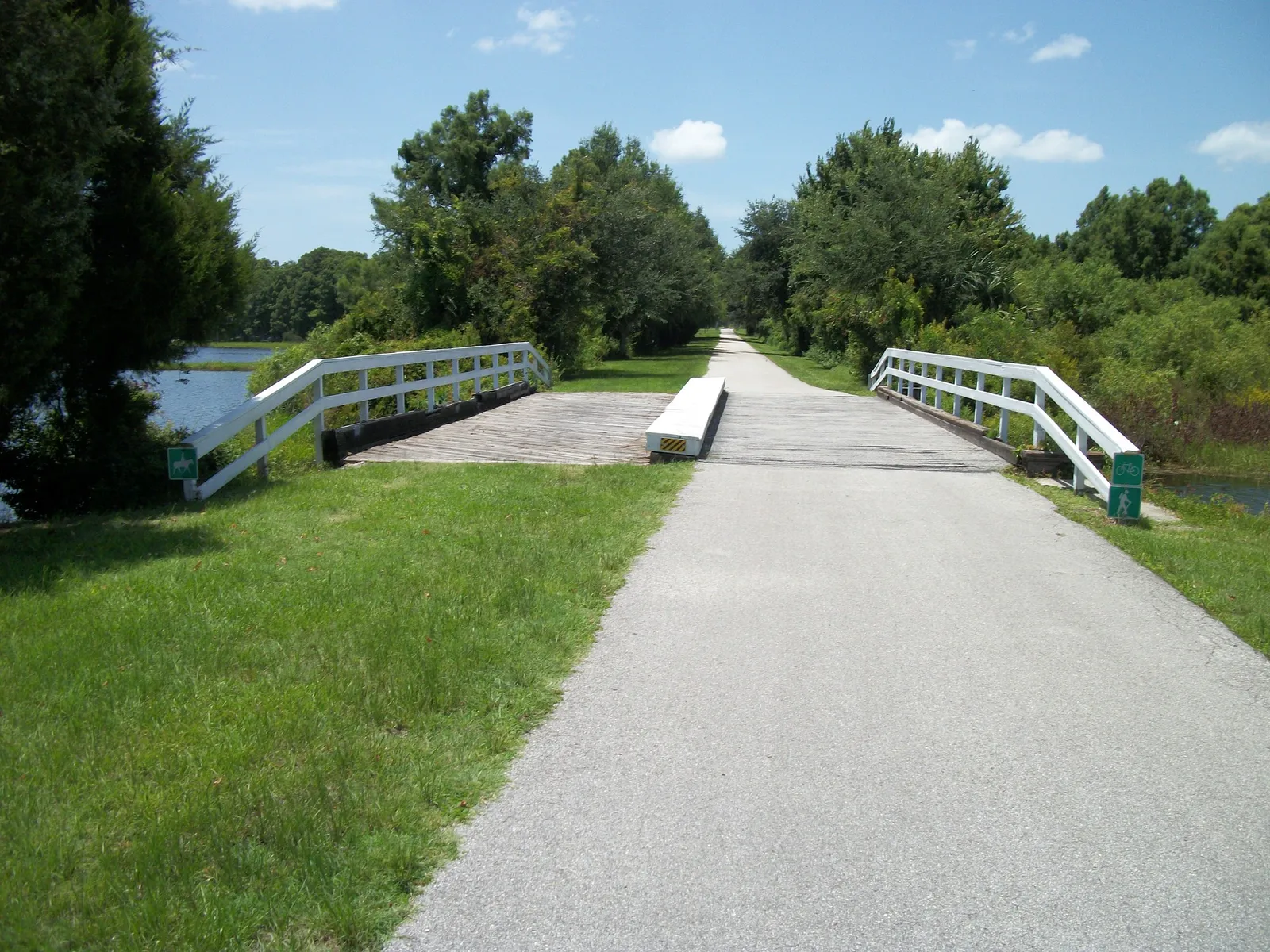 Paved recreation trail crossing a bridge near Henderson Lake